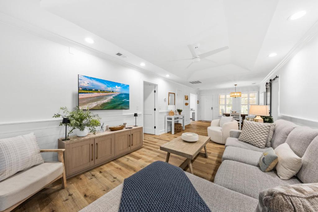 a living room with a couch and a table at 1147 Summerwind Cottage in Seabrook Island