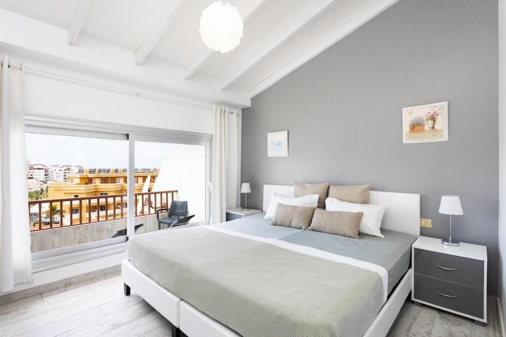 Ένα ή περισσότερα κρεβάτια σε δωμάτιο στο Bright & Elegant Duplex with Terrace and Pool, Just Steps from Puerto Colón
