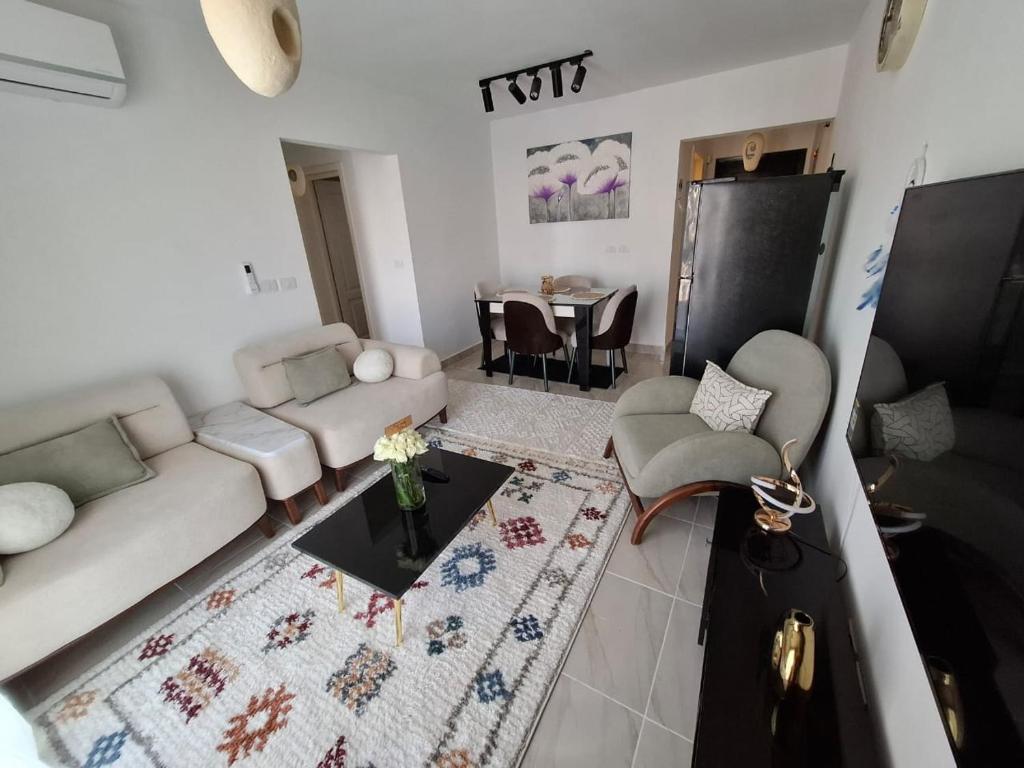 a living room with a couch and a table at Modern City Apartment in Cairo