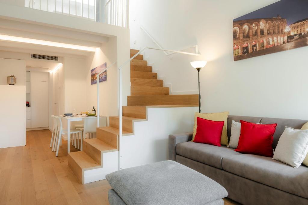 Hotel Magica Verona Castelvecchio, a living room with a couch and a staircase at Magica Verona Castelvecchio in Verona