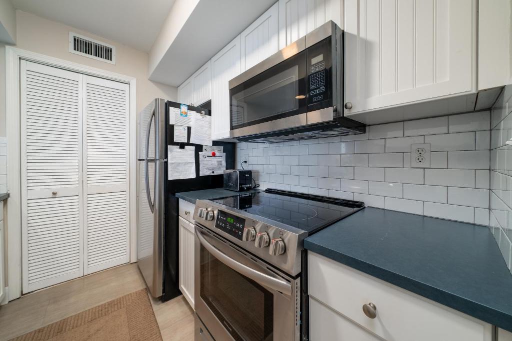 a kitchen with a stove and a refrigerator at 1304 Pelican Watch Villa in Seabrook Island
