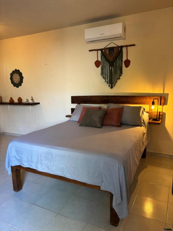 a bedroom with a large bed with a white comforter at Jungla Bacalar in Bacalar