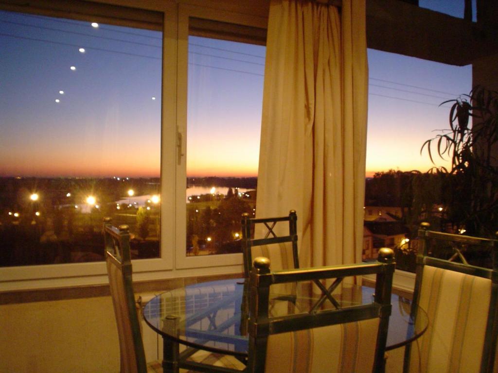 a table and two chairs on a balcony with a view at Soltejo in Vila Nova da Barquinha