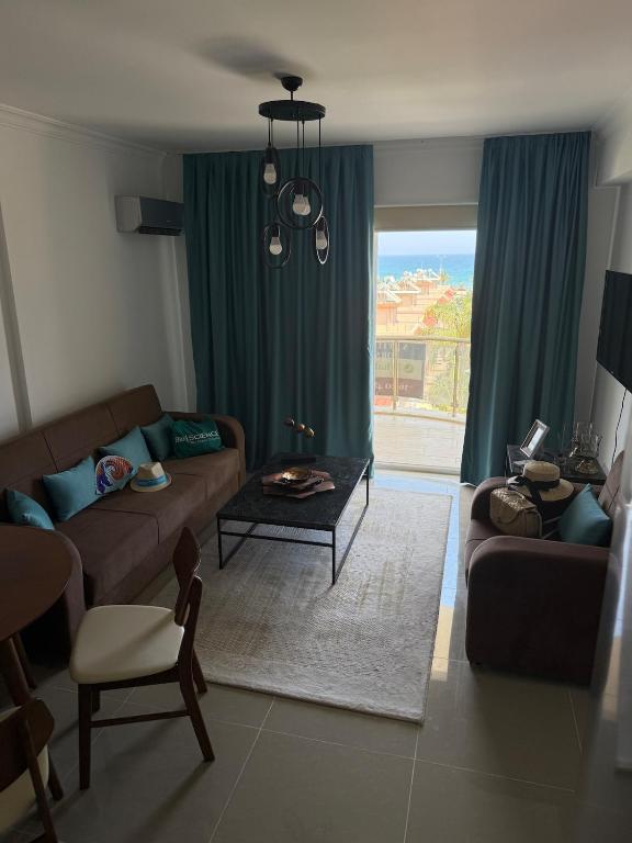 a living room with a couch and a table at Two Bedrooms LongBeach SeaView Escape in Paralimni