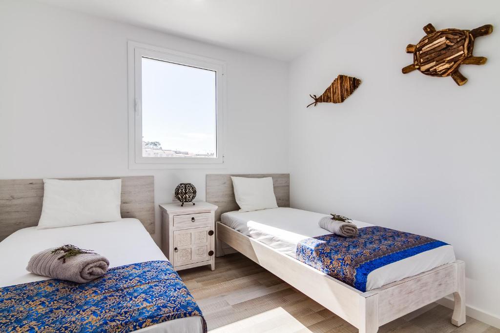 Postel nebo postele na pokoji v ubytování Vista Roses Mar - Villas Batik