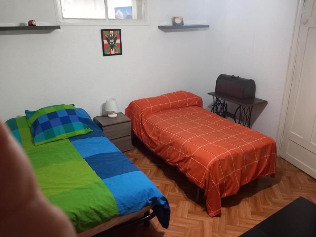 a bedroom with two beds and a suitcase on the floor at Iberia-sestao in Sestao