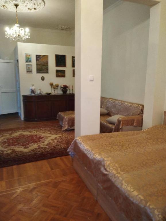 a bedroom with a bed and a couch in a room at Barateli in Kutaisi