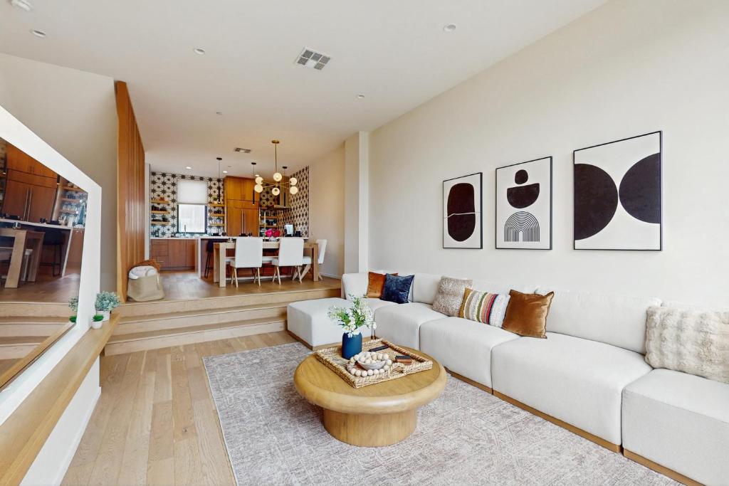 a living room with a white couch and a table at Sea & Stroll Abode - Beautiful dog friendly home in Carlsbad Village w/private grill, backyard, W/D in Carlsbad