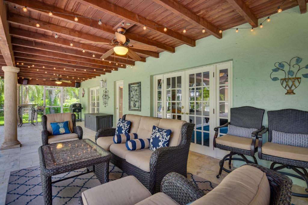 a patio with a couch and chairs on a porch at 16 Mi to Fort Lauderdale Florida Escape with Pool! in Plantation