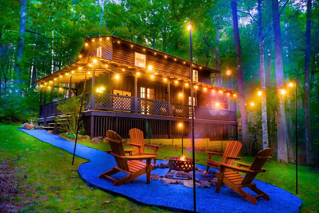 a house with a fire pit and chairs and lights at Meadow Retreat - Hot Tub, Fire Pit & Games in Morganton