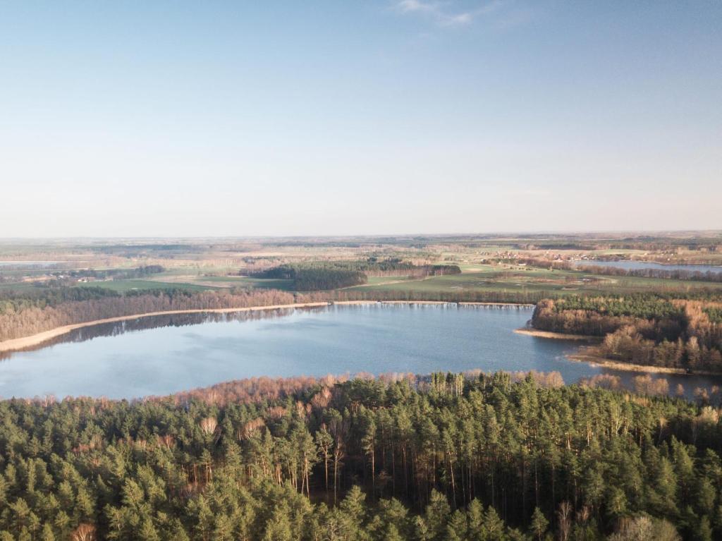 an aerial view of a lake in the woods at Gunram Mazury in Okowizna