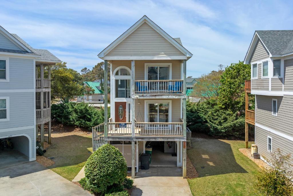 a house with a porch and a balcony at Corolla & Lime in Corolla