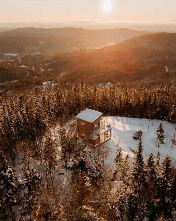 a house on a hill in the snow at Le Hélios - MicroChalet au Maelstrom in Lac-Beauport