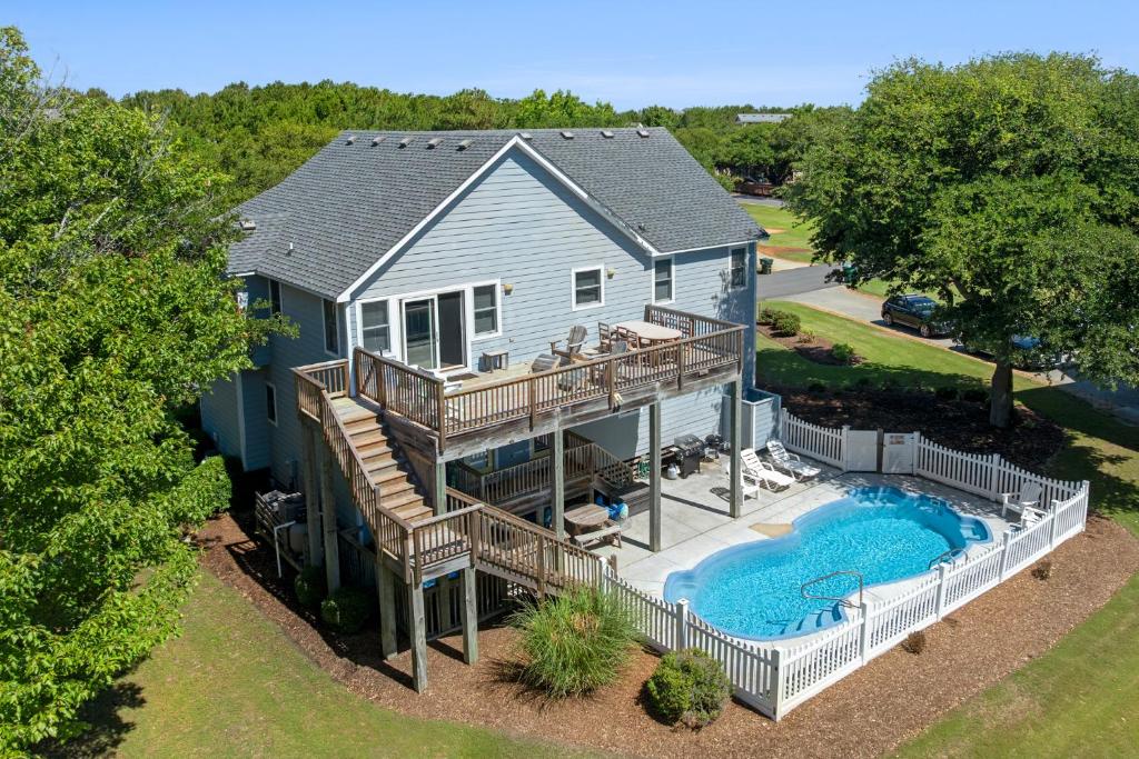 an aerial view of a house with a deck and a swimming pool at Country Roads in Corolla