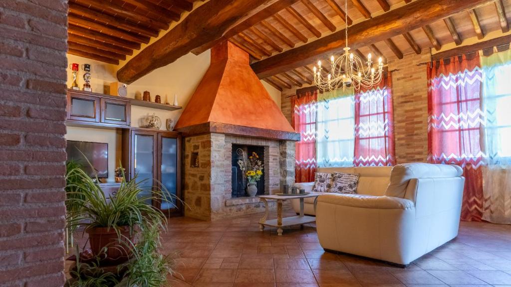 a living room with a couch and a fireplace at Podere le Fonti in Poggibonsi
