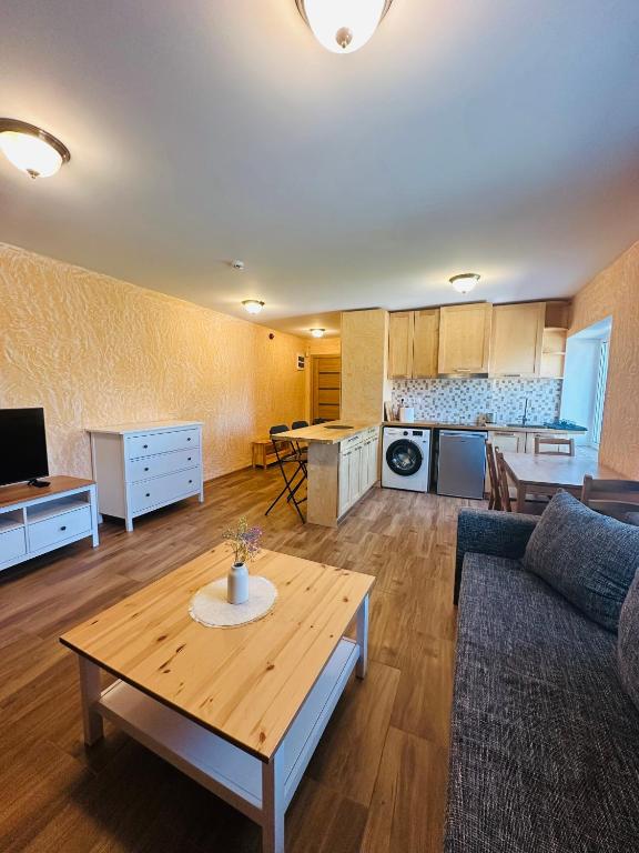 a living room with a couch and a table at Rožu namu apartamenti 4 in Kuldīga