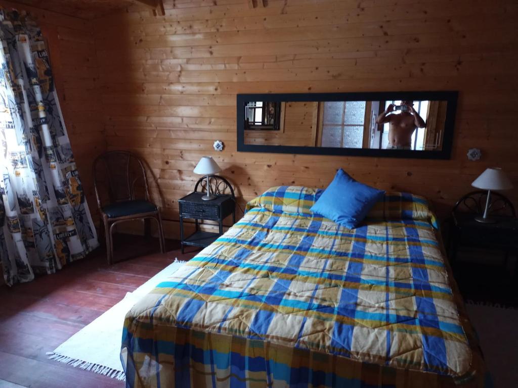 a bedroom with a bed and a mirror on the wall at Casa Tamadaba in Agaete
