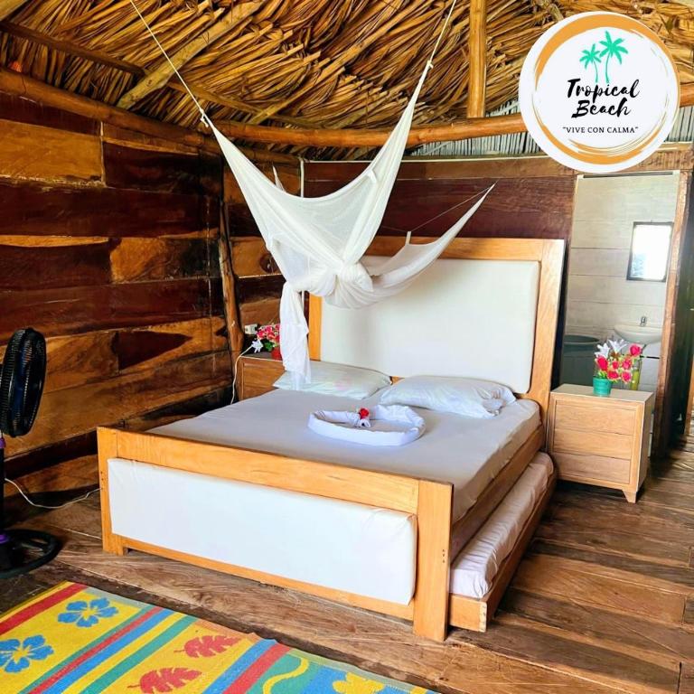 a bed with a hammock in a room at Tropical Beach in Playa Blanca