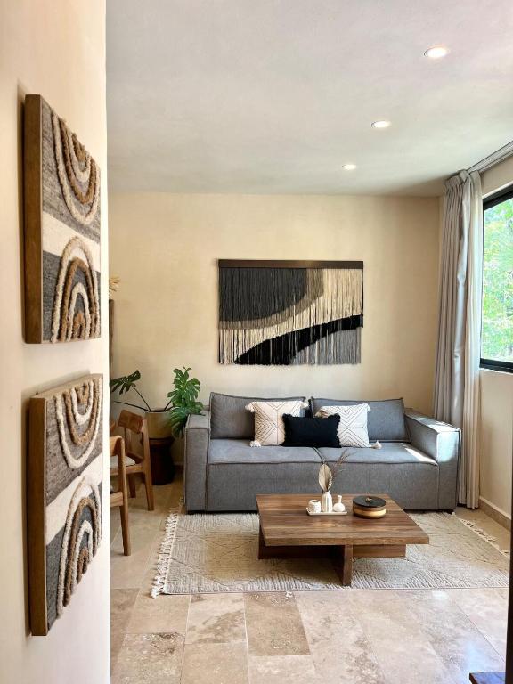 a living room with a couch and a table at Villa with a private pool in Tulum