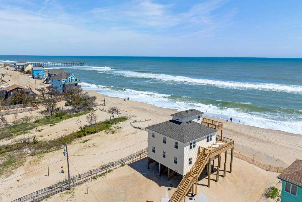 an aerial view of a beach with a building and the ocean at Everlasting Moon in Rodanthe