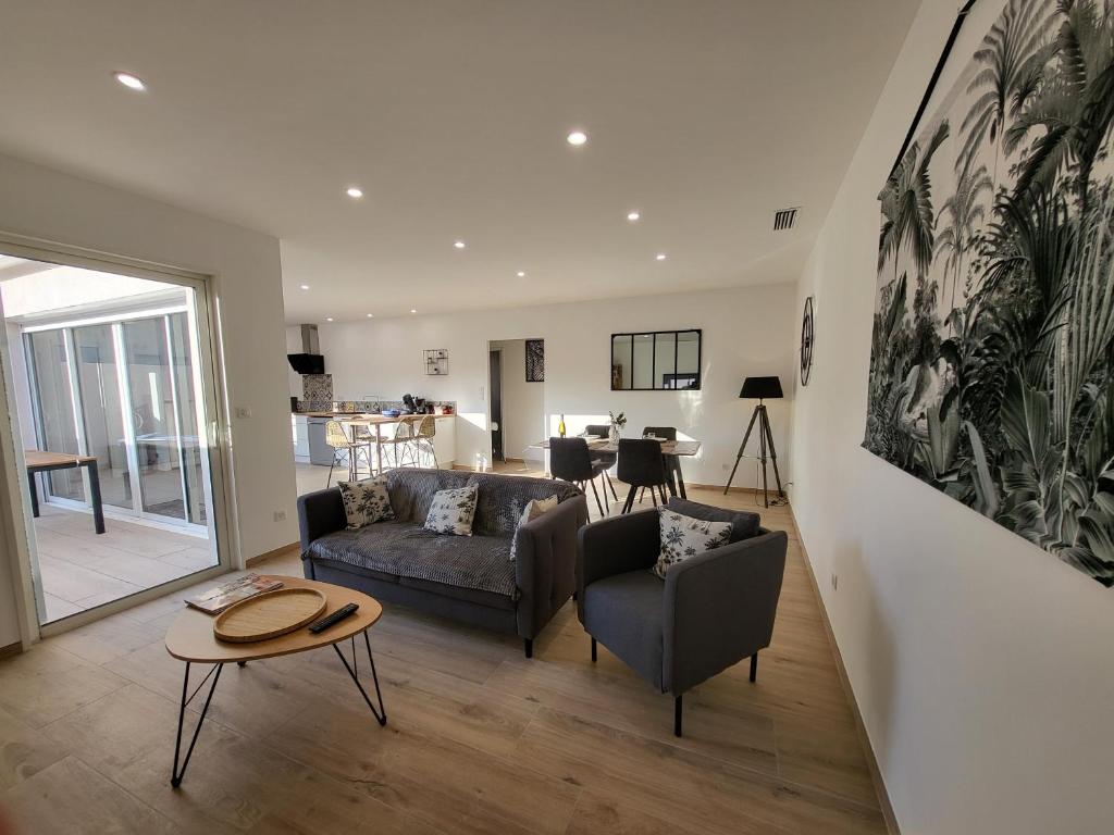 a living room with a couch and a table at La grange d'augustin in Saint-Thibéry