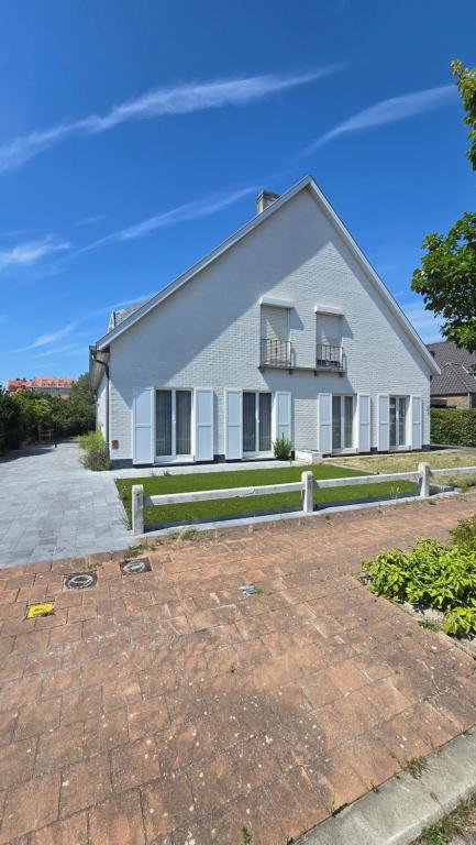 a white house with two balconies on it at Sea Home in Middelkerke