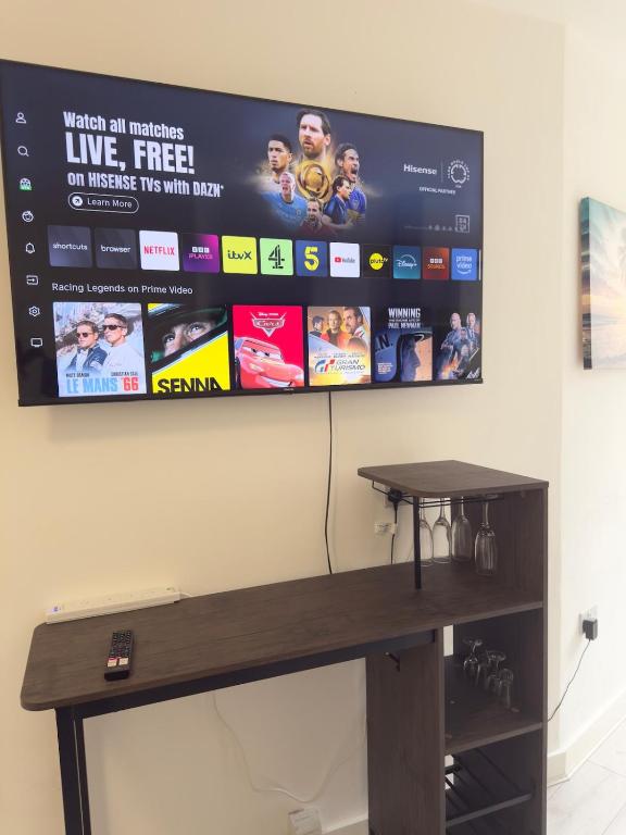 a flat screen tv hanging on a wall at Central Wigan Stay in Wigan