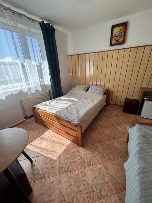 a bedroom with a bed in the corner of a room at Willa Anna in Mielno
