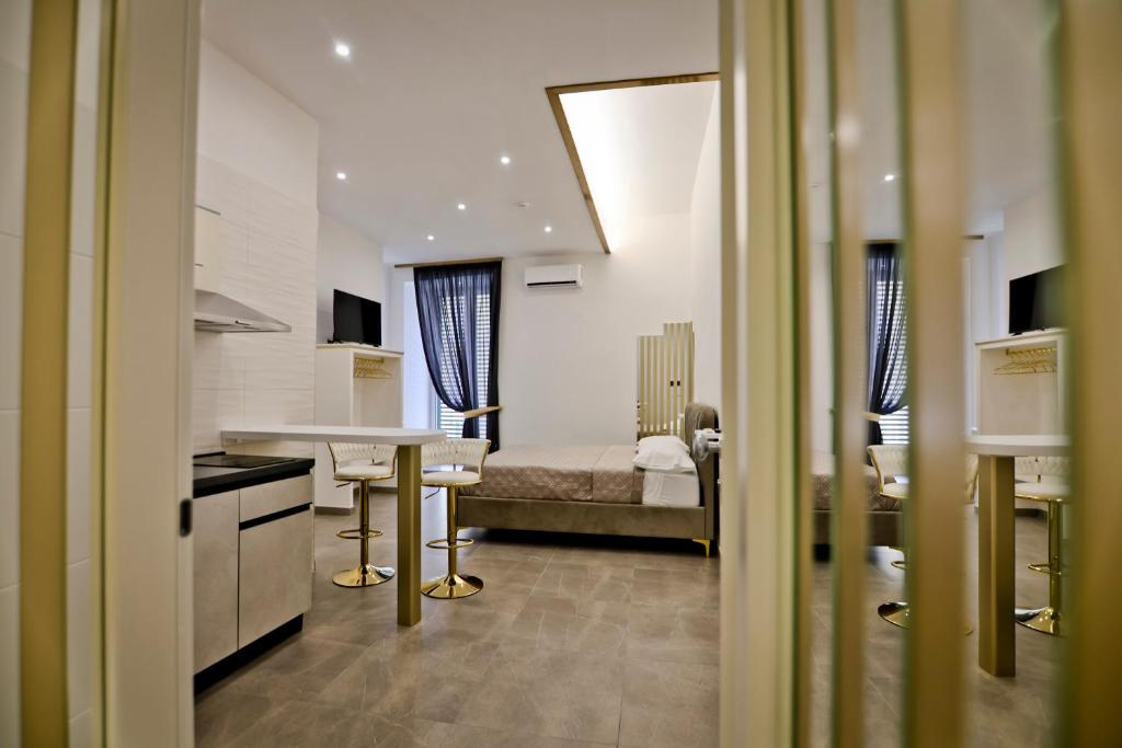 a kitchen with a couch and a table in a room at Dante Luxury Rooms in Naples
