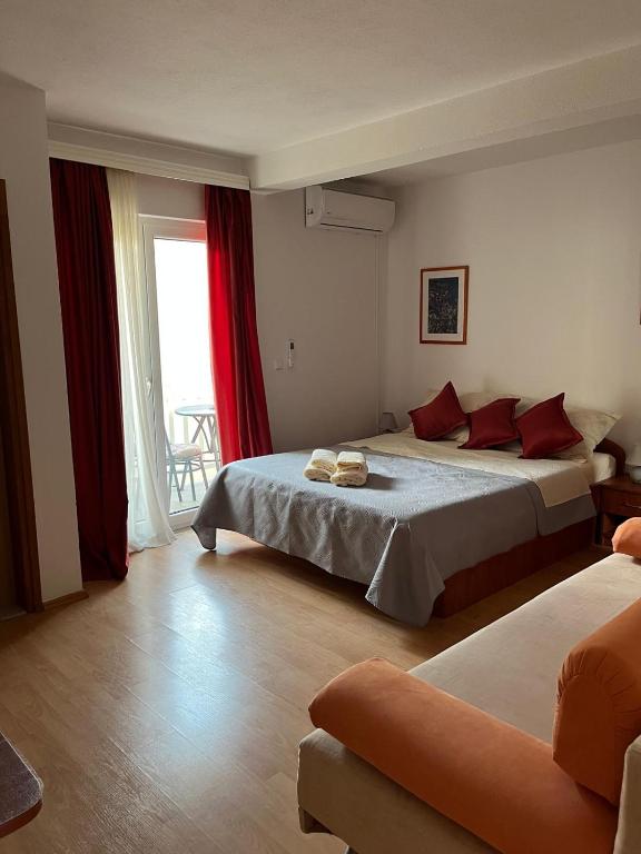 a hotel room with two beds and a couch at Rooms Raguž in Neum