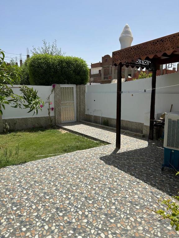 a patio with a gazebo and a fence at The House Of Love in Luxor