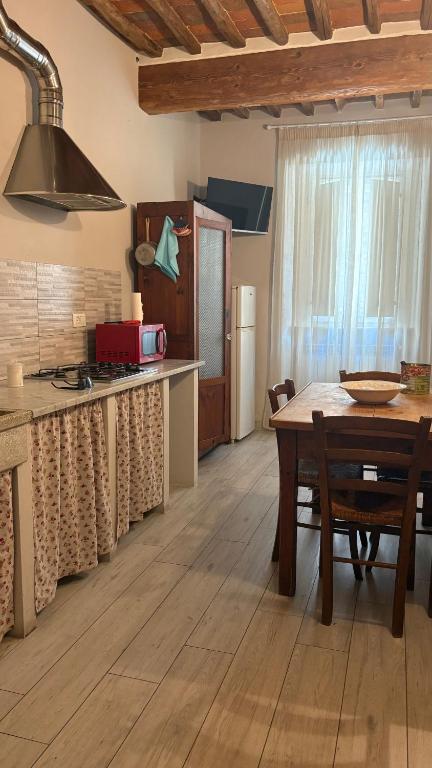 a kitchen with a table and a dining room at Lodge San Romano 16 in Lucca