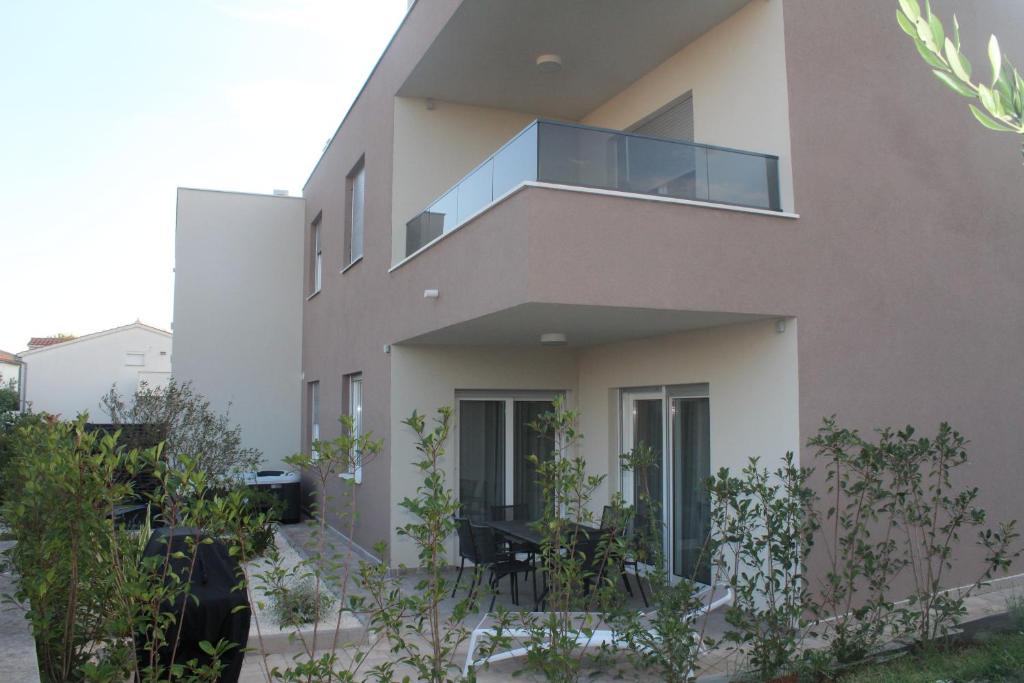 a house with a balcony in front of it at Wiki in Vodice
