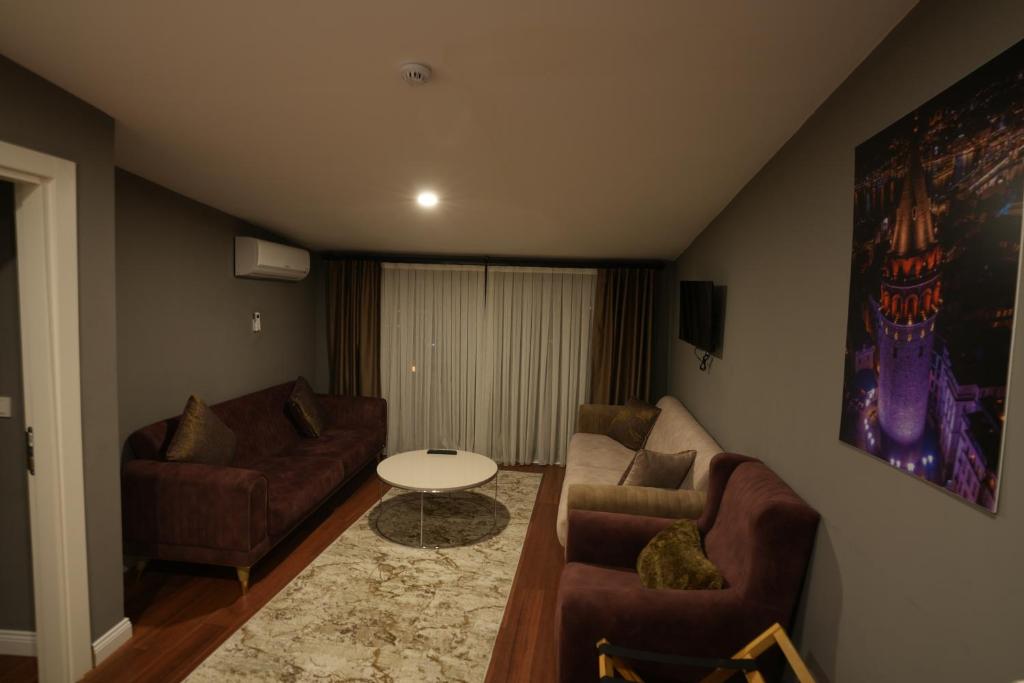 a living room with two couches and a table at Suites Hotel in Istanbul