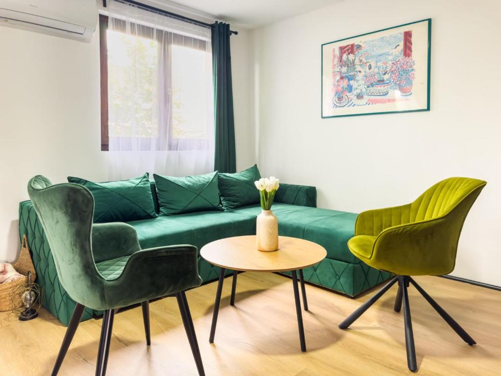 a living room with a green couch and chairs at Golubački visovi in Golubac