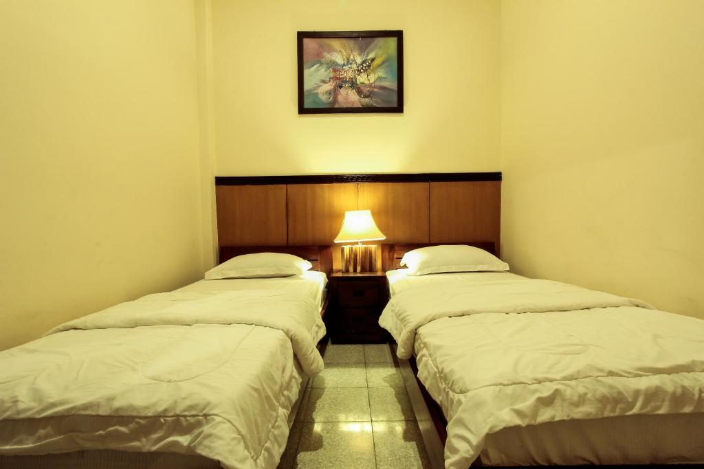 Postel nebo postele na pokoji v ubytování Griya Langen Guesthouse