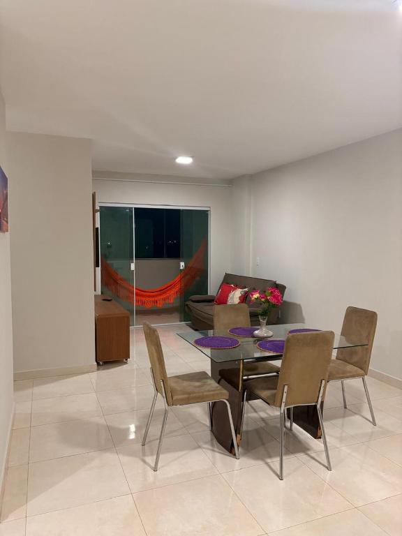 a living room with a table and chairs and a couch at Apto de 3 Quartos Vista lateral do Mar a 2km da praia do Araçagy in São Luís