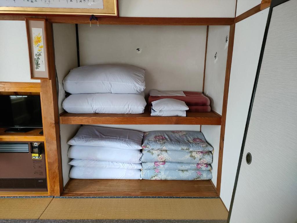 Postel nebo postele na pokoji v ubytování たかね荘