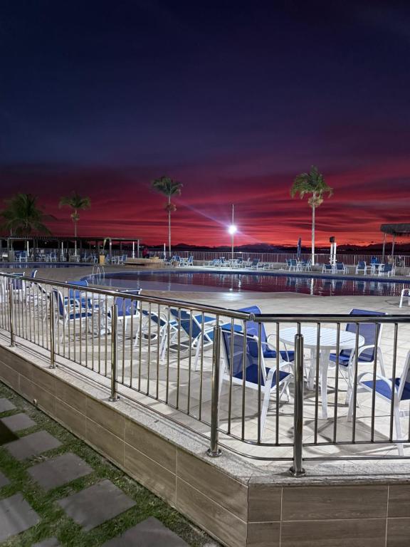 a row of chairs in a parking lot at night at Arraial do Cabo RJ - Golden Lake in Arraial do Cabo
