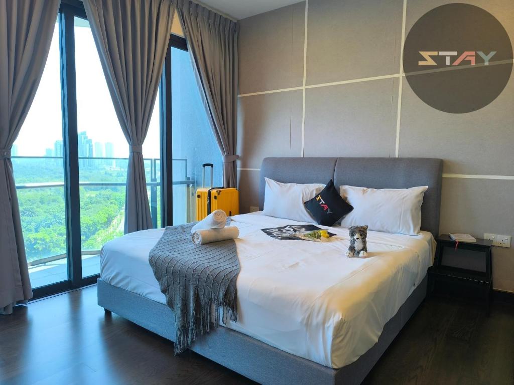 a bedroom with a bed with two stuffed animals on it at Almas Modern Warm Studio Puteri Harbour BySTAY in Nusajaya