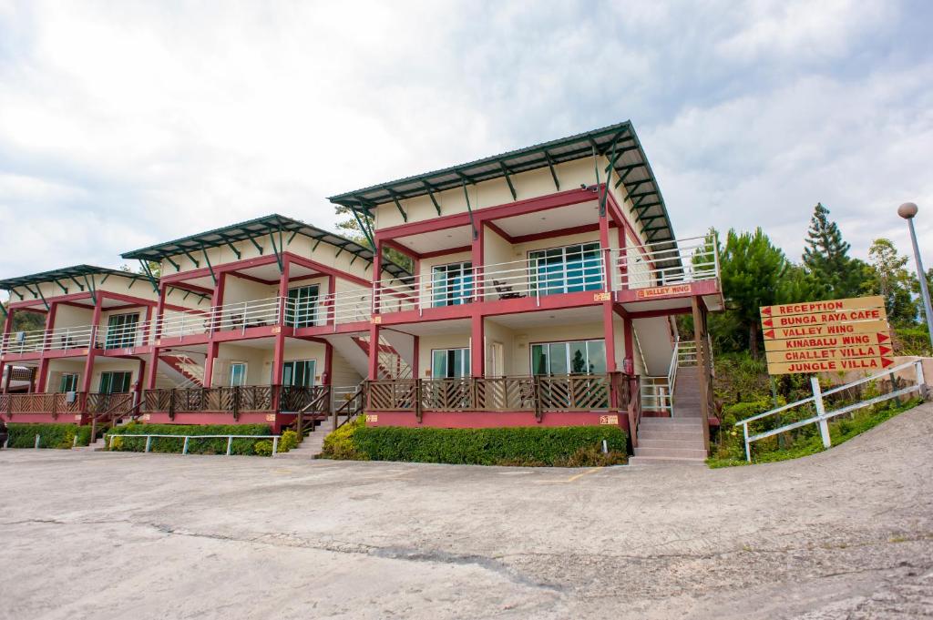 a pink building with a sign in front of it at Celyn Resort Kinabalu in Kampong Kundassan