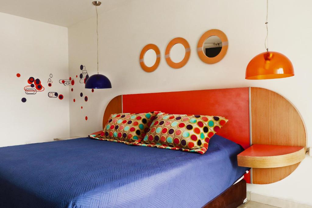 Postel nebo postele na pokoji v ubytování Hotel Portobelo Guatape
