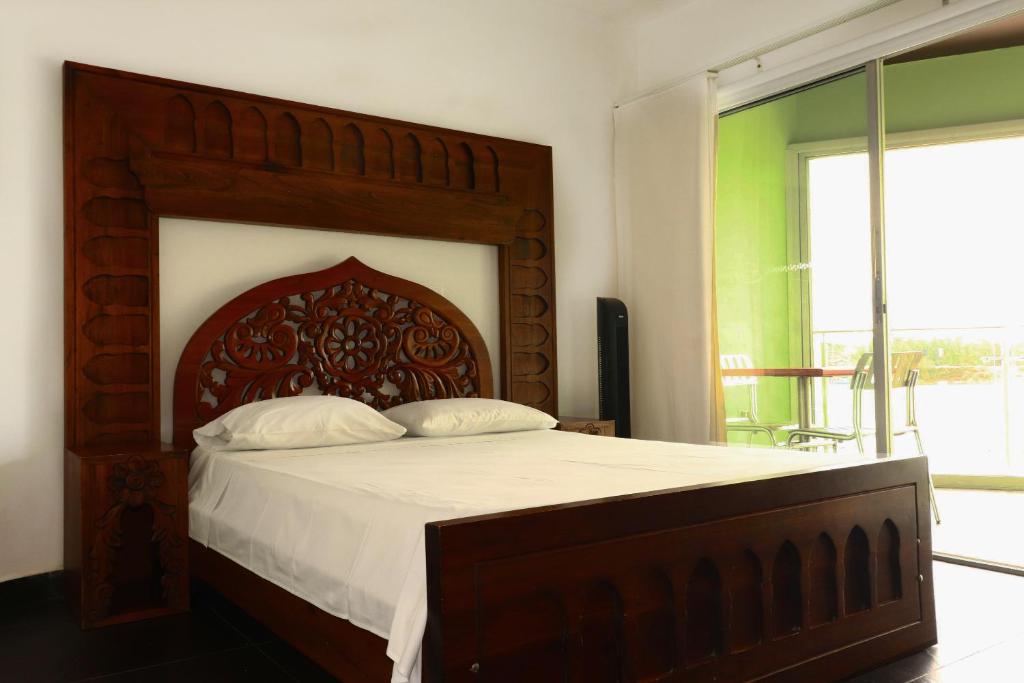 Postel nebo postele na pokoji v ubytování Hotel Portobelo Guatape