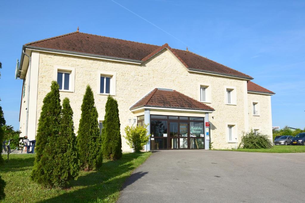a large building with trees in front of it at Logis Des Sources in Créney-près-Troyes