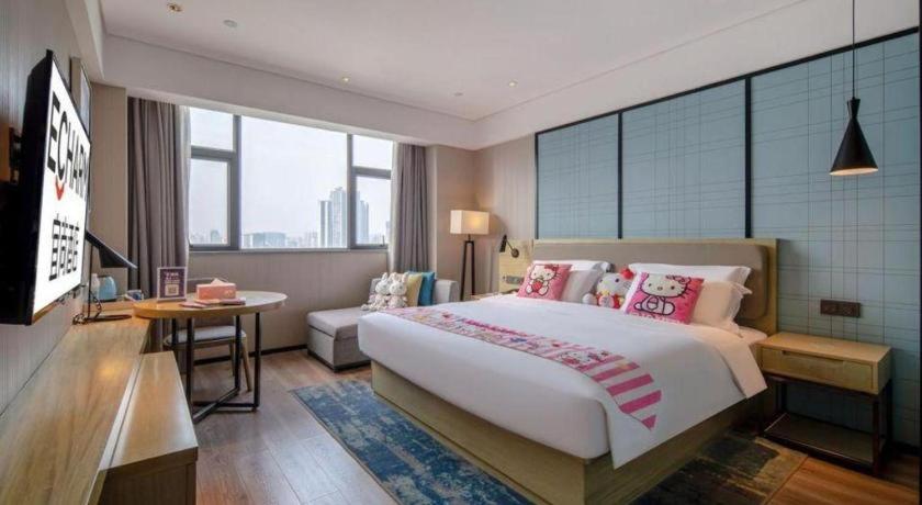 Ένα ή περισσότερα κρεβάτια σε δωμάτιο στο Echarm Hotel Nanning Chaoyang Square River View