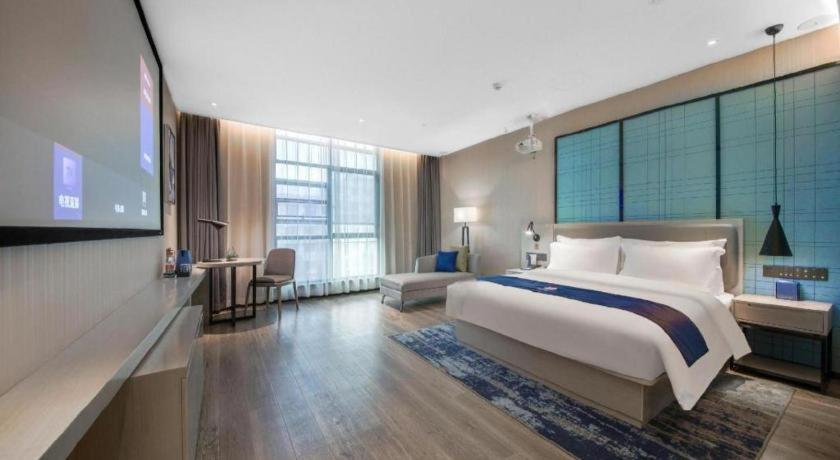 Postel nebo postele na pokoji v ubytování Echarm Hotel An'xi Hengxing Coach Station