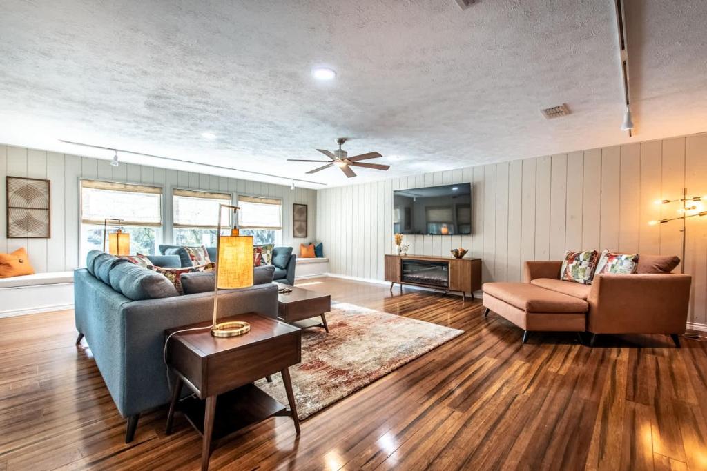 a living room with a blue couch and a table at Classic Coastal Getaway Sleeps 34 - 2 Homes 2 Pools in Corpus Christi