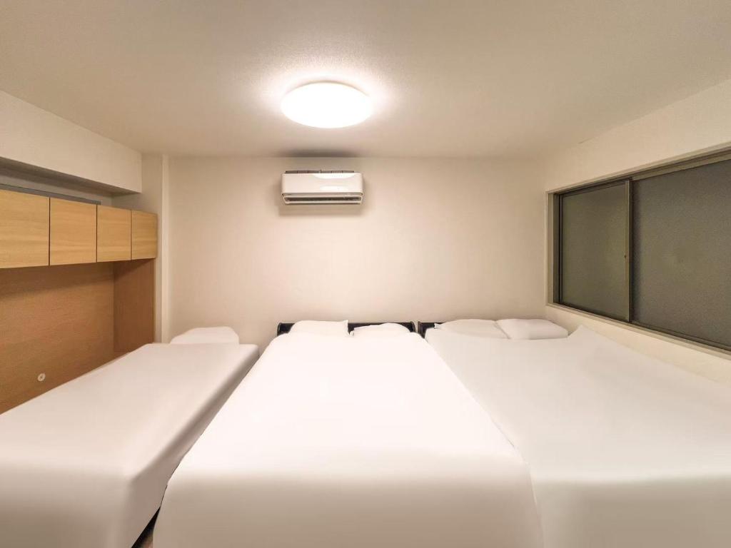 A bed or beds in a room at 渡边ビル101