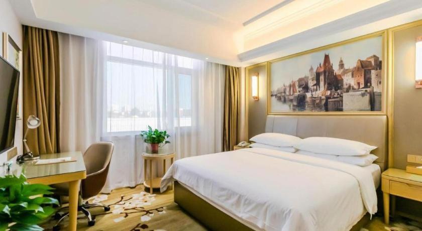 Postel nebo postele na pokoji v ubytování Vienna Hotel Shandong Qingdao Jiaodong International Airport Hai'er Avenue