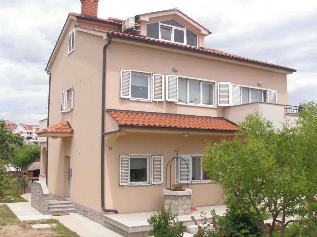 una grande casa con persiane bianche di Apartment Veglia a Krk
